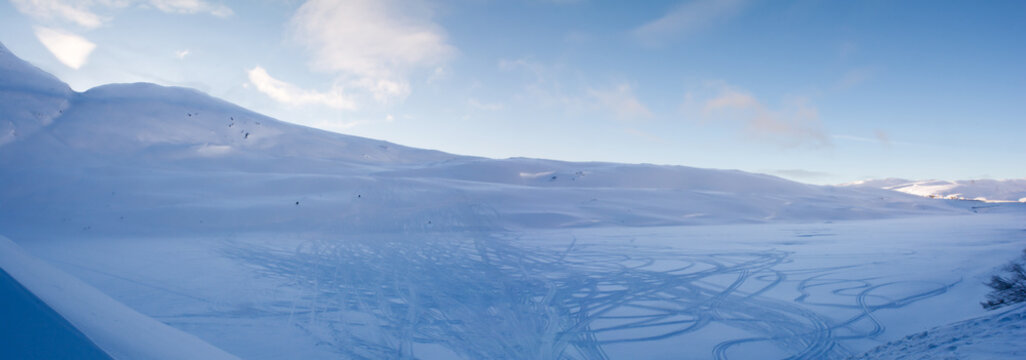 Shadowed Snow Bowl Covered With Tracks