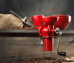Red coffee mill and coffee beans