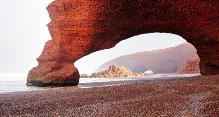 Natural stony arch at Legzira beach, near Sidi Ifni, south of Agadir in Morocco.