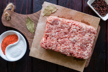 minced meat and spices on a black background