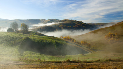 Autumn in the mountains - rural foggy landscape of high hills