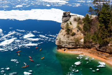 Kayaks at Miners Castle on Lake Superior. Late ice breakup created unusual ice formations at Pictured Rocks National Lakeshore in the Upper Peninsula of Michigan