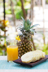 Glass of pineapple smoothie, juice and fresh fruit