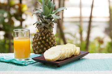 Glass of pineapple smoothie, juice and fresh fruit