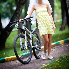 Bride on a bicycle in the Park