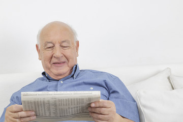 Old man reading newspaper