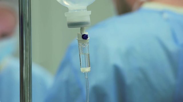 A dropper in surgery is ticking during doctor saving pacient