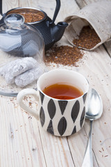 Cup of healthy traditional herbal rooibos red beverage tea with