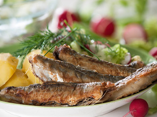 Fried herring with salad
