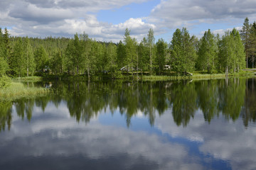Fototapeta na wymiar Clouds in the lake. Northern Finland