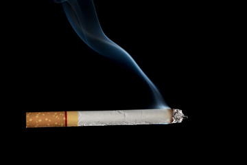 cigarette with smoke on black background
