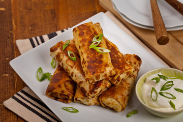 Traditional Russian Fried Stuffed Pancakes Blintzes with Meat. Selective focus.