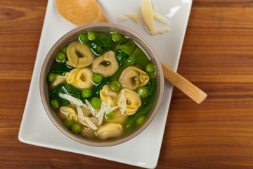 Tortellini Soup with Peas and Spinach. Selective focus.