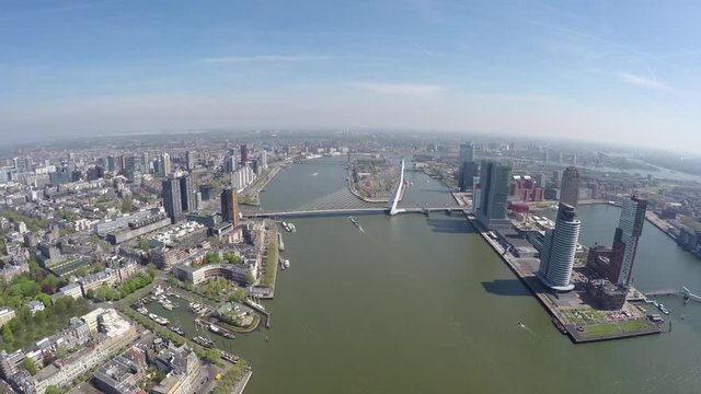 Aerial of Rotterdam city high altitude footage of Erasmus Bridge Erasmusbrug and business dsitrict right cityscape bird view city center large city in south of Holland great tourist attraction 4k