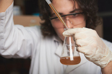 student mixing chemicals