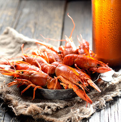 boiled crawfish and beer on a wooden background
