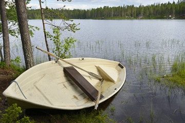 Obraz premium Lonely boat after rain. Northern Finland