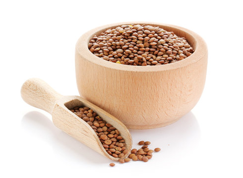 Brown lentils in wooden bowl