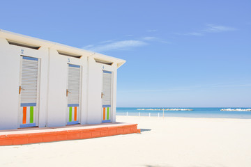 Cabins on the Adriatic beach and sea in the background