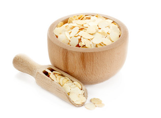 Dried yellow pea flakes in wooden bowl
