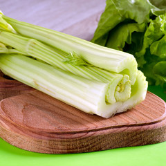 Celery stalks cut into slices on a kitchen Board