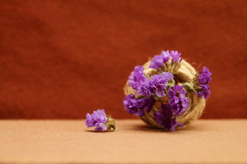 decorative composition of twine and flowers on a brown background