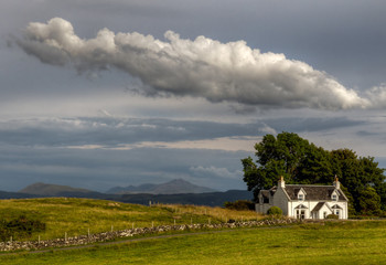Scottish cottage with scottish fence and big cloud above, Isle of Lismore, Scotland