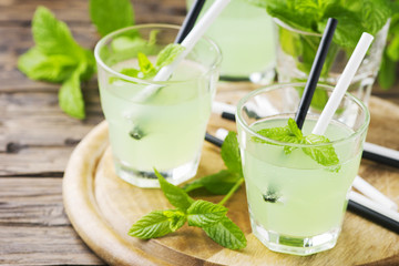 Green sweet alcohol cocktail with mint and ice