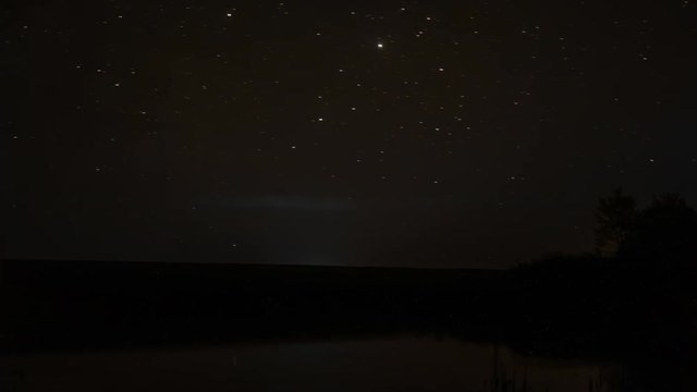 timelapse video of rotating stars in the night sky over rocky river and sunrise rotation of stars at night over lake nature sleeps, the time lapse twilight, beautiful stars night shooting stars