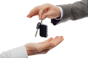 Hands and car key isolated on white background