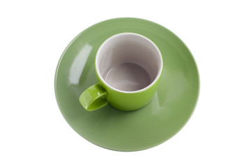 green empty cup on the plate
