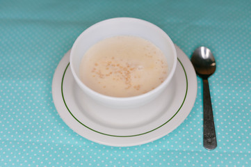 Top view on bowl of oats porridge on a table background. Healthy breakfast
