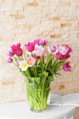 Bouquet of beautiful tulips on brick wall background