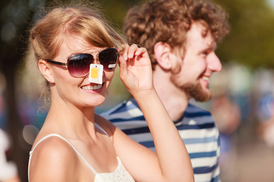 young couple buying new sunglasses outdoor