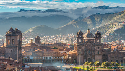 Morning sun rising at Plaza de armas with Adean Moutain and grou - obrazy, fototapety, plakaty