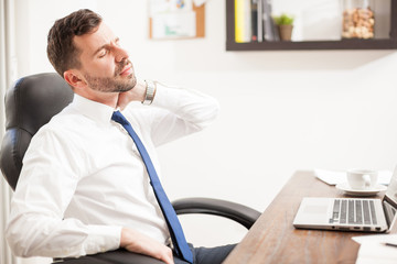 Young businessman with neck pain