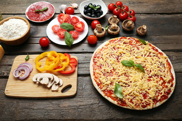 Food ingredients for pizza on table close up