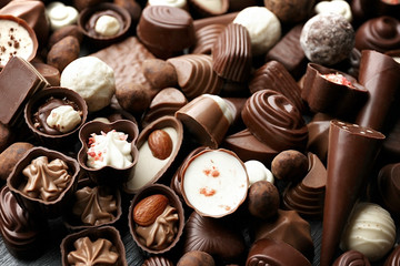 Assortment of delicious chocolate candies background, close up