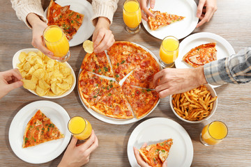 Friendly party with hot pizza and drinks, close up