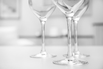 Wineglasses on blurred interior background