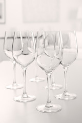 Wineglasses on blurred interior background