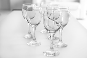 Wineglasses on blurred interior background