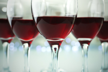 Glasses of red wine on white table closeup