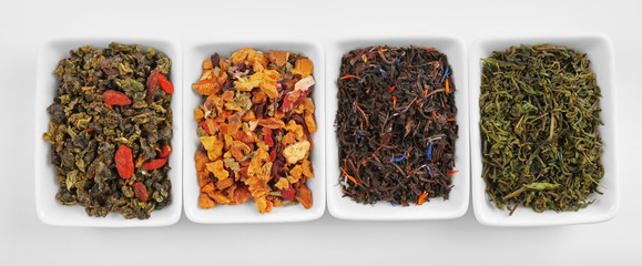 Variety of tea leaves, isolated on white