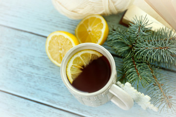 Beautiful winter composition with cup of hot drink, on wooden table