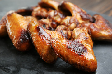Baked chicken wings on slate plate
