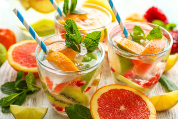 Refreshing cocktails with ice, mint, pomegranate seeds and slices of fruits