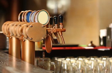 Draught beer taps in a bar.