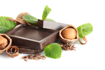 Chocolate with mint and hazelnuts on white background