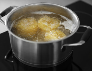 Boiling nest pasta in pan on electric stove in the kitchen
